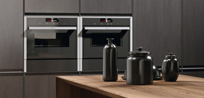 electrodomésticos modernos para tu cocina. Cocinas de diseño en Lanzarote. Mobiliario de color negro, dos hornos de diseño y vajilla negra.